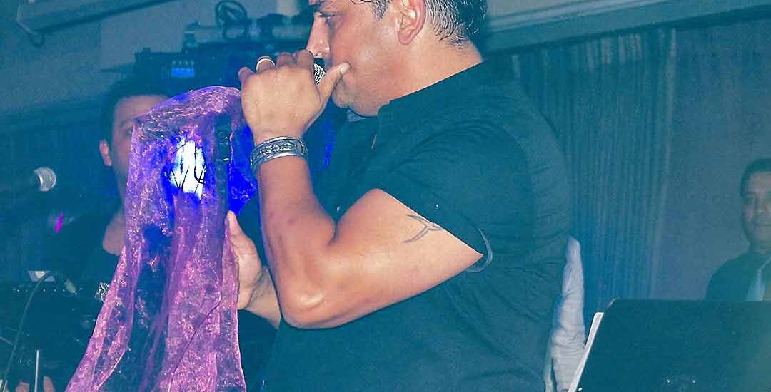 Siavash Shams performing live on stage in Auckland with vibrant energy, alongside Arash Armand, a professional keyboard player and musician based in Auckland.