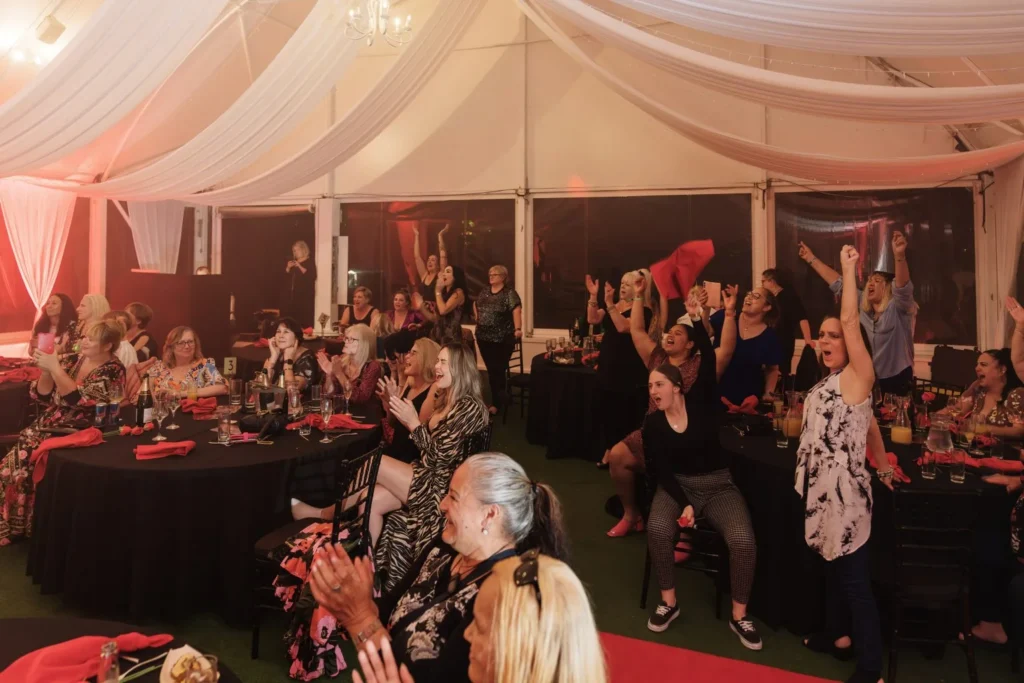 A lively group of attendees enjoying themselves on the dance floor at Allely Estate's Men of Steel event, capturing the night's fun and energetic vibe.