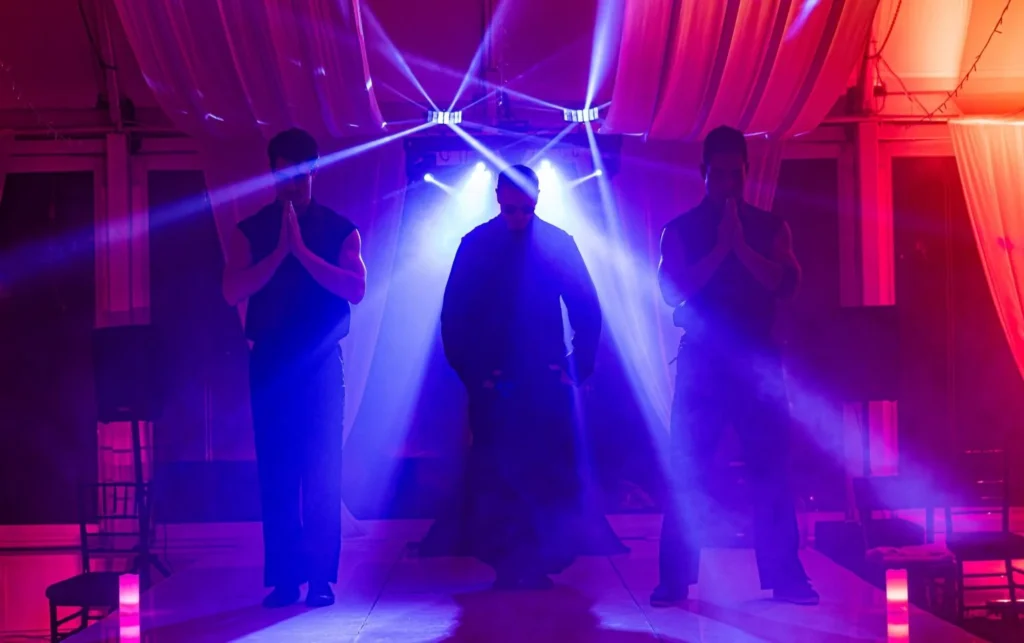 Dark stage illuminated with blue and red lights during the Men of Steel performance at Allely Estate, photographed by Auckland weddings and events photographer HAPfilm.