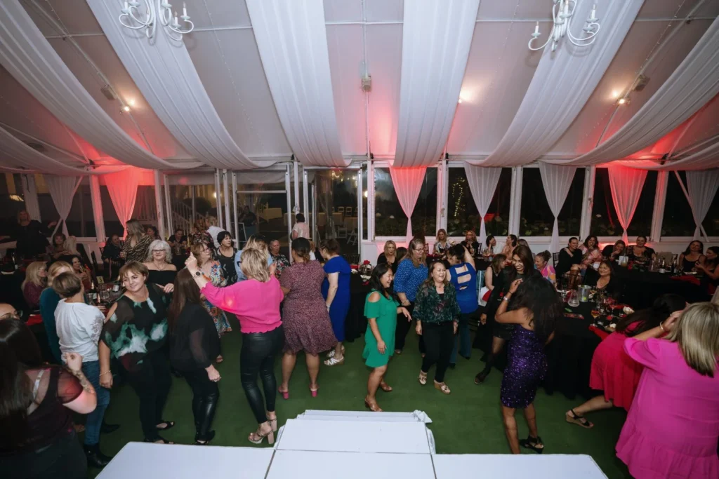 Guests dancing energetically at Allely Estate during the Men of Steel event, surrounded by a festive atmosphere and vibrant lighting.