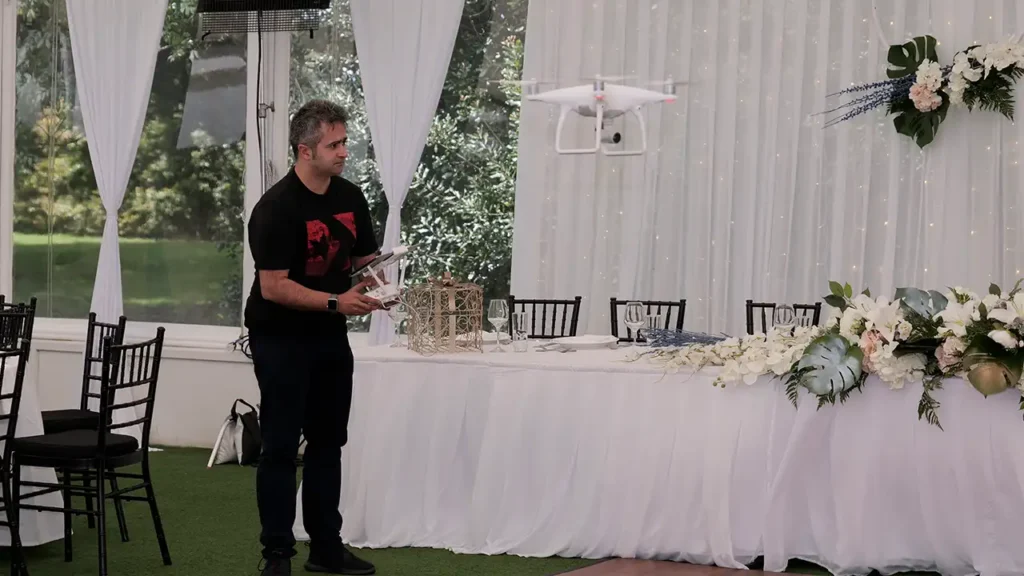 HAPfilm team flying a drone above the decorated marquee at Allely Estate, capturing aerial shots of the event setup.